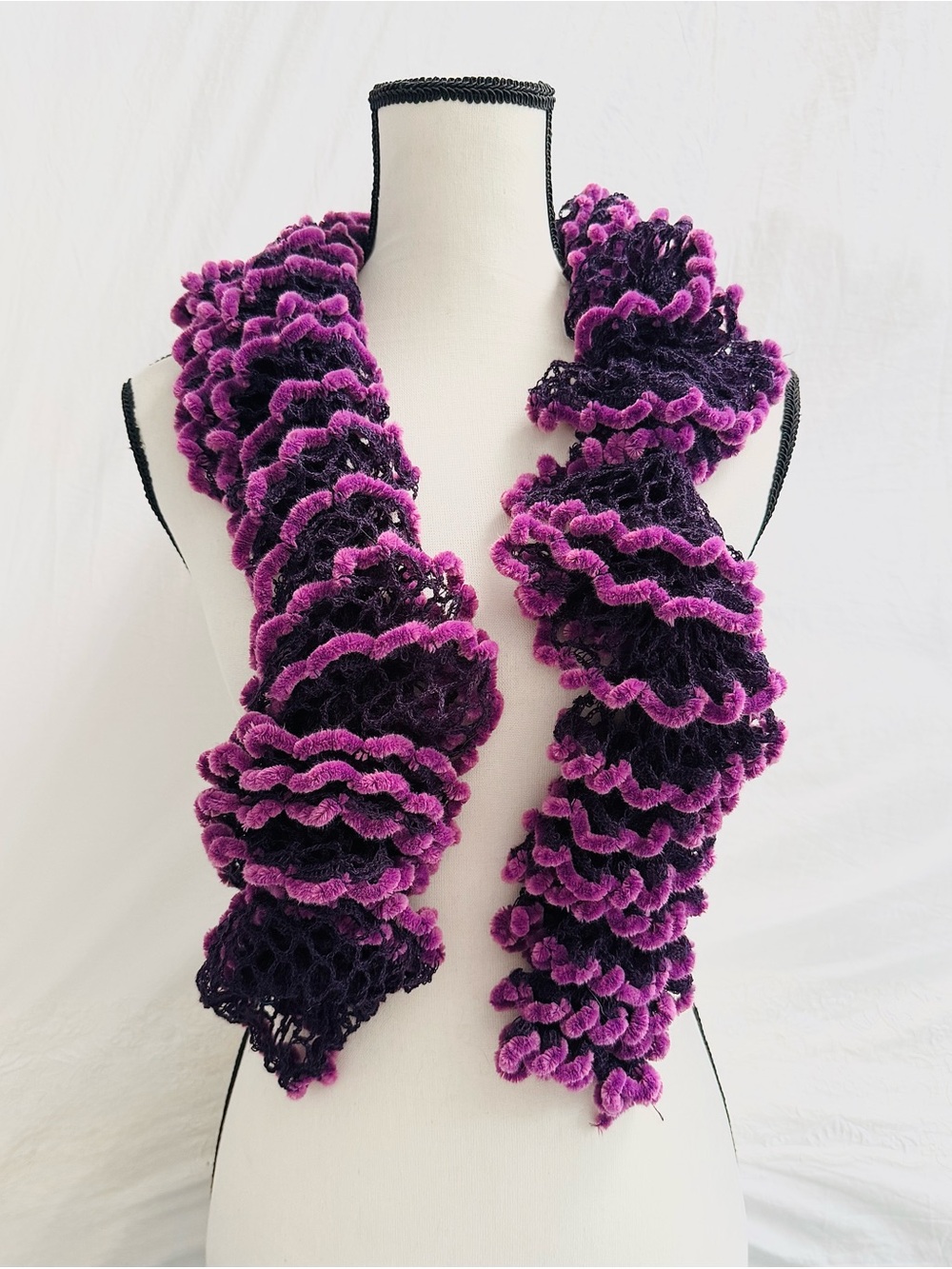 Handmade crochet scarf with ruffled texture in purple and black
